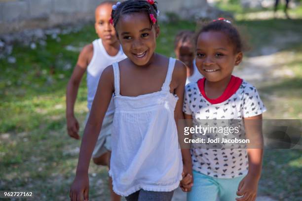 Jamaican children playing outside in poor village
