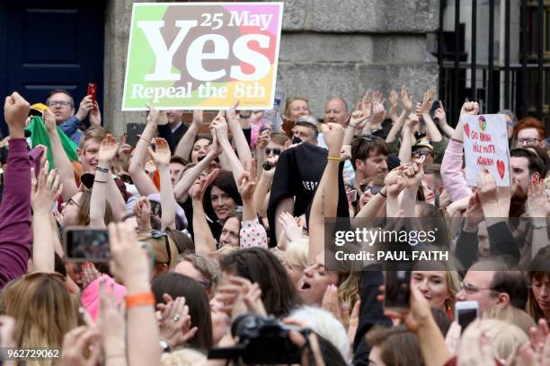 'Yes' campaigners celebrate the official result of the Irish abortion referendum at Dublin Castle in Dublin on May 26, 2018 which showed a landslide...