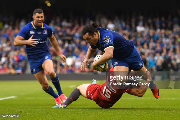 Dublin , Ireland - 26 May 2018; James Lowe of Leinster is tackled by Leigh Halfpenny of Scarlets during the Guinness PRO14 Final between Leinster and...