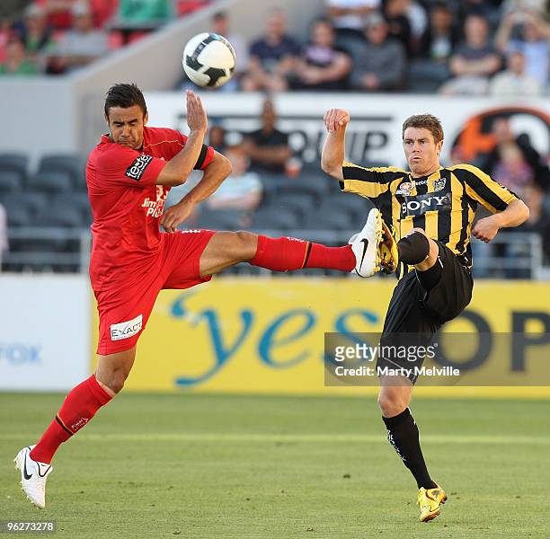 Tony Lochhead of the Phoenix gets tackled by Travis Dodd captain of Adelaide during the round 25 A-League match between Wellington Phoenix and...