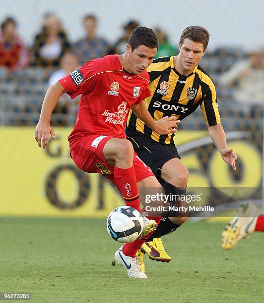 Mathew Leckie of Adelaide gets tackled by Tony Lochhead of the Phoenix during the round 25 A-League match between Wellington Phoenix and Adelaide...