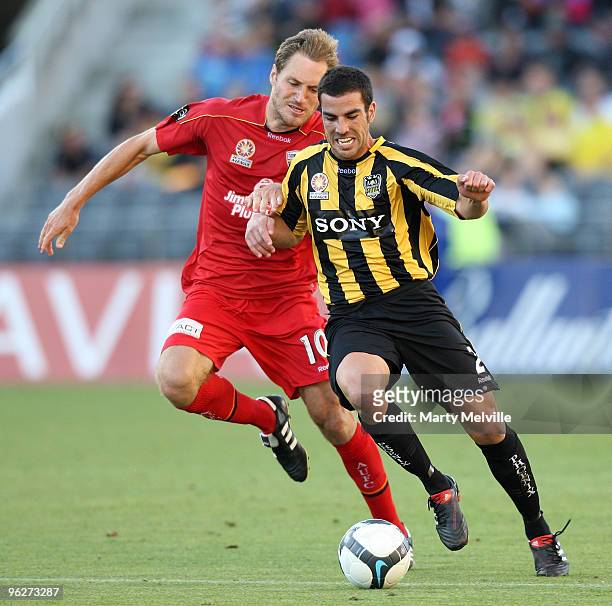 Manny Muscat of the Phoenix gets tackled by Adam Hughes of Adelaide during the round 25 A-League match between Wellington Phoenix and Adelaide United...