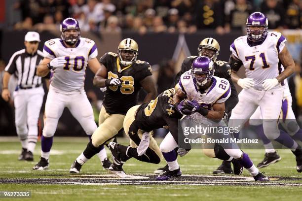 Adrian Peterson of the Minnesota Vikings runs the ball against the New Orleans Saints during the NFC Championship Game at the Louisana Superdome on...