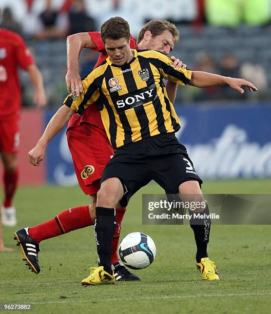 Tony Lochhead of the Phoenix gets tackled by Adam Hughes of Adelaide during the round 25 A-League match between Wellington Phoenix and Adelaide...