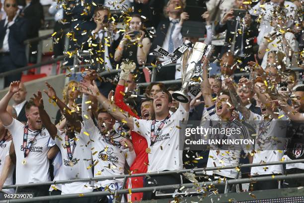 Fulham's Scottish midfielder Kevin McDonald and Fulham's English midfielder Tom Cairney lift the trophy for Fulham after the English Championship...