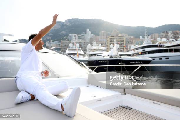 Daniel Ricciardo of Australia and Red Bull Racing relaxes on a boat in the harbour after qualifying for the Monaco Formula One Grand Prix at Circuit...