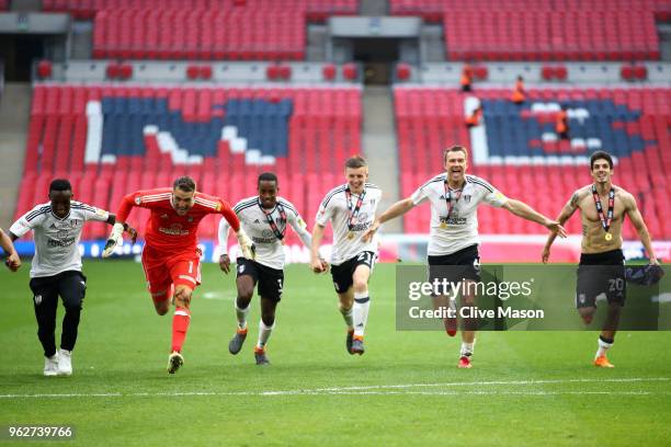 Fulham players celebrate on the pitch following their sides victory in the Sky Bet Championship Play Off Final between Aston Villa and Fulham at...