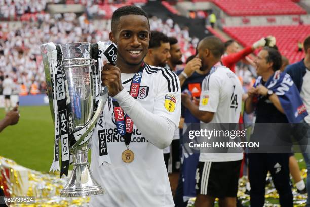 Fulham's English defender Ryan Sessegnon celebrates with the trophy on the pitch after the English Championship play-off final football match between...