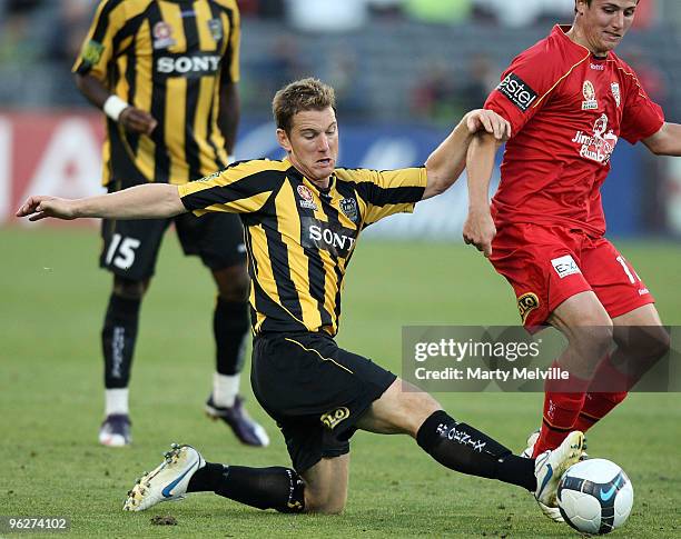 Chris Greenacre of the Phoenix tackles Michael Marrone of Adelaide during the round 25 A-League match between Wellington Phoenix and Adelaide United...