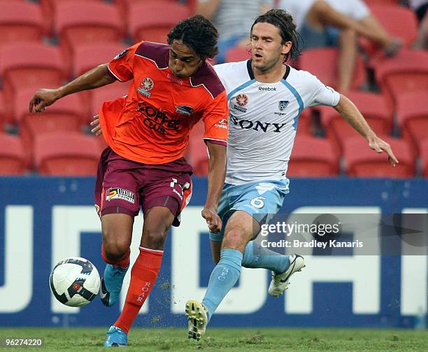 Adam Sarota of the Roar is pressured by the defence of Karol Kisel Sydney during the round 25 A-League match between the Brisbane Roar and Sydney FC...
