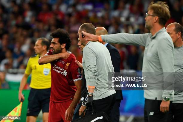Liverpool's Egyptian forward Mohamed Salah waits to come back on after hurting his shoulder during the UEFA Champions League final football match...