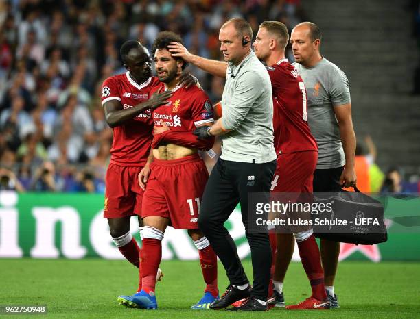 Sadio Mane and Jordan Henderson console team mate Mohamed Salah of Liverpool as he leaves the pitch injured during the UEFA Champions League Final...