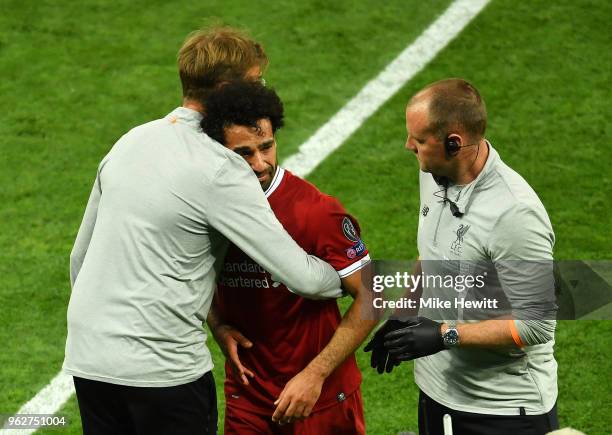 Jurgen Klopp, Manager of Liverpool greets Mohamed Salah of Liverpool as he leaves the pitch injured during the UEFA Champions League Final between...