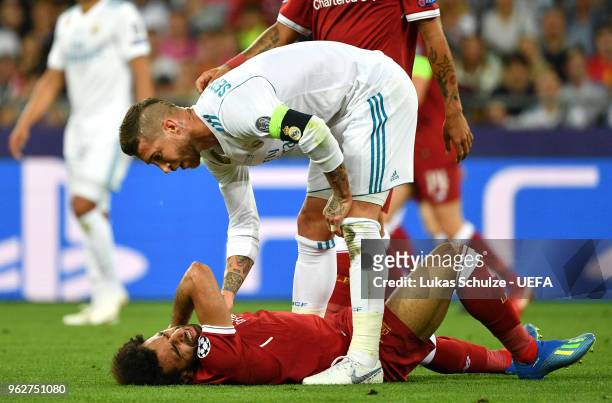 Sergio Ramos of Real Madrid consoles Mohamed Salah of Liverpool as he goes down injured during the UEFA Champions League Final between Real Madrid...