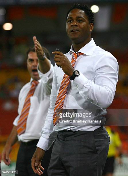 Former Dutch international player Patrick Kluivert and Roar coach Ange Postecoglou watch on eagerly from the sideline during the round 25 A-League...
