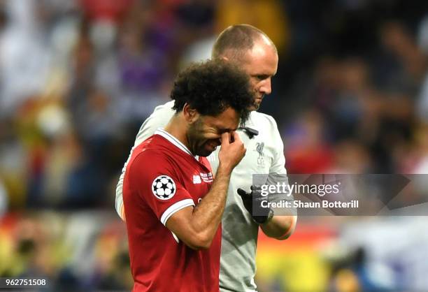 Mohamed Salah of Liverpool reacts whilst leaving the pitch injured during the UEFA Champions League Final between Real Madrid and Liverpool at NSC...