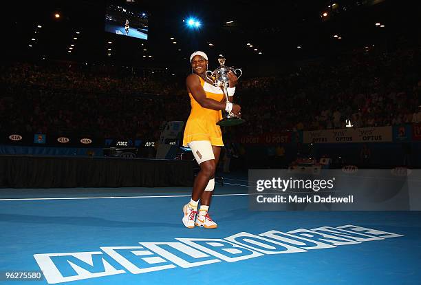 Serena Williams of the United States of America poses with the Daphne Akhurst Trophy after winning her women's final match against Justine Henin of...