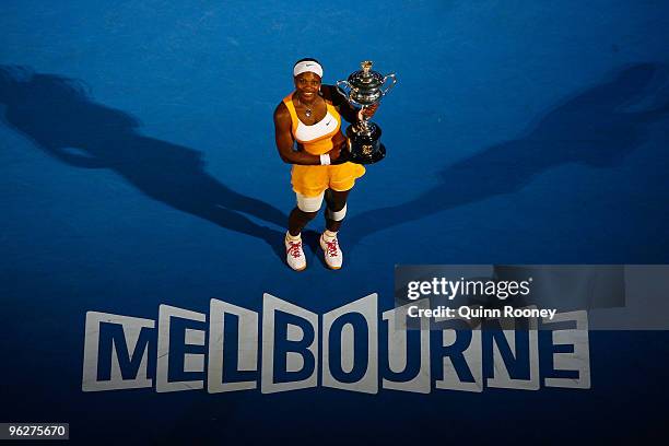 Serena Williams of the United States of America poses with the Daphne Akhurst Trophy after winning her women's final match against Justine Henin of...