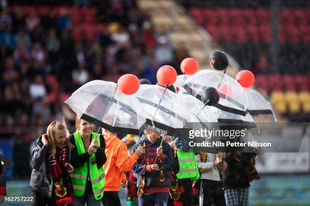 Young fans with umbrellas to protect the from the water sprinklers ahead of the Allsvenskan match between Ostersunds FK and BK Hacken at Jamtkraft...