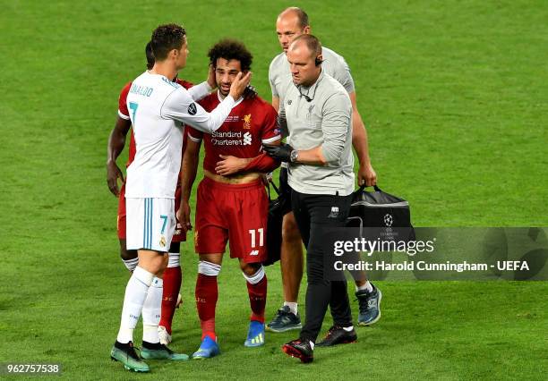 Cristiano Ronaldo of Real Madrid consoles Mohamed Salah of Liverpool as he leaves the pitch injured during the UEFA Champions League Final between...