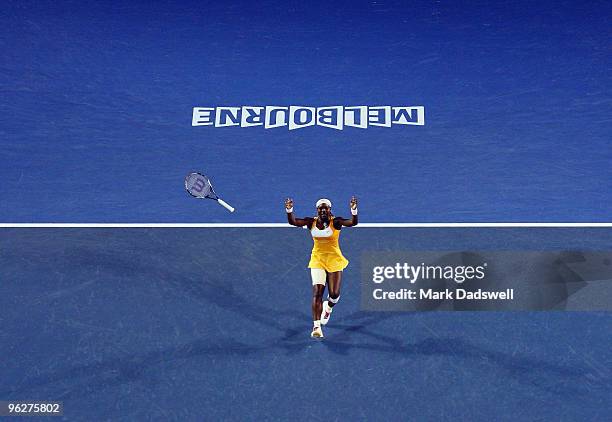 Serena Williams of the United States of America throws her racquet into the air after winning championship point in her women's final match against...