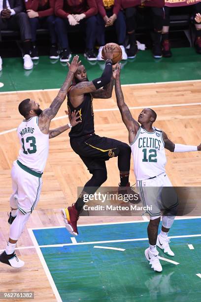 LeBron James of the Cleveland Cavaliers passes the ball against Terry Rozier and Marcus Morris of the Boston Celtics during Game Five of the 2018 NBA...