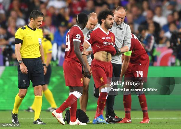 Sadio Mane consoles team mate Mohamed Salah of Liverpool as he leaves the pitch injured during the UEFA Champions League Final between Real Madrid...