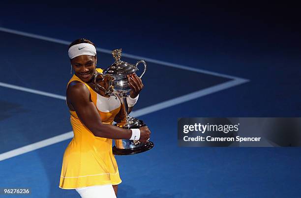 Serena Williams of the United States of America poses with the Daphne Akhurst Trophy after winning her women's final match against Justine Henin of...