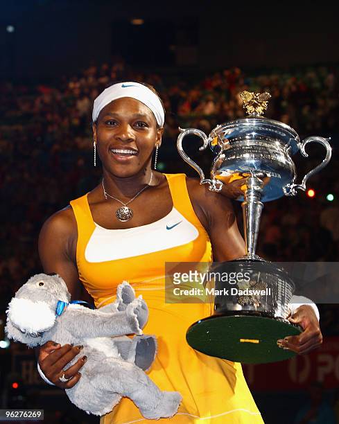 Serena Williams of the United States of America poses with the Daphne Akhurst Trophy after winning her women's final match against Justine Henin of...