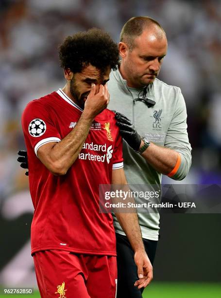 Mohamed Salah of Liverpool reacts whilst leaving the pitch injured during the UEFA Champions League Final between Real Madrid and Liverpool at NSC...