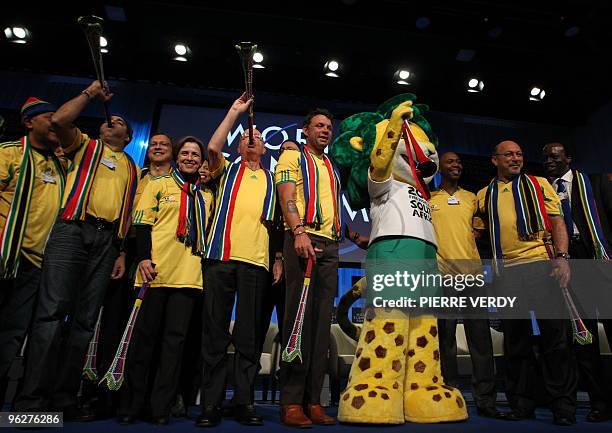 South African delegation members pose with World Economic Forum founder and Chairman Klaus Schawb during the Davos kickoff for the 2010 FIFA World...