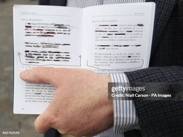 Man holds redacted copy of of the constitution at Dublin Castle as Ireland has voted to repeal the Eighth Amendment to the Constitution which...