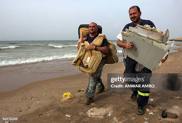 Lebanese civil defence members carry the debris of an Ethiopian airliner that crashed off Lebanon after searching the coast of Beirut on January 30,...