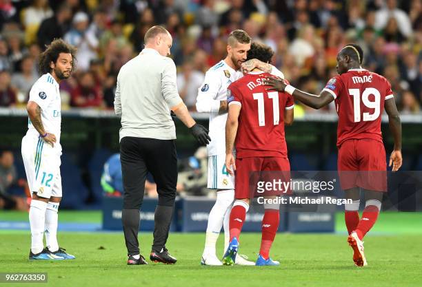 Sergio Ramos of Real Madrid consoles Mohamed Salah of Liverpool as he leaves the pitch injured during the UEFA Champions League Final between Real...