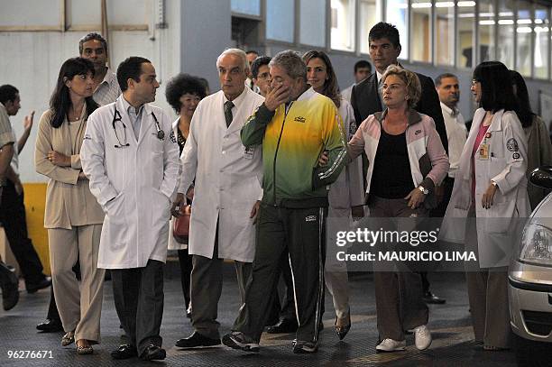 Brazilian President Luiz Inacio Lula da Silva is seen surrounded by doctors alongside first lady Marisa Leticia after concluding medical...