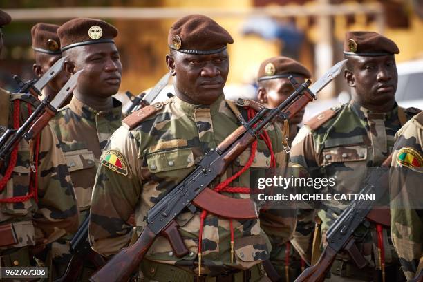 Soldiers are pictured during the funeral of griot singer Kasse Mady Diabate on May 26, 2018 in Bamako. - Kasse Mady Diabate died on May 24, 2018 at...