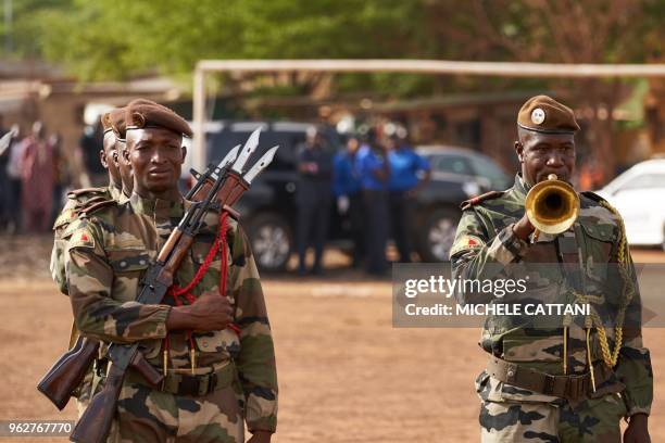 Soldiers are pictured during the funeral of griot singer Kasse Mady Diabate on May 26, 2018 in Bamako. - Kasse Mady Diabate died on May 24, 2018 at...