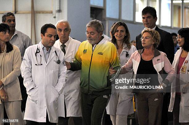 Brazilian President Luiz Inacio Lula da Silva is seen surrounded by doctors alongside first lady Marisa Leticia after concluding medical...
