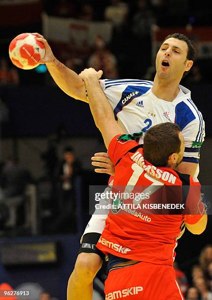 France's Jerome Fernandez is fouled by Iceland's Sverre Jakobsson on January 30 during the EHF EURO 2010 Handball Championship semi-final Iceland vs....