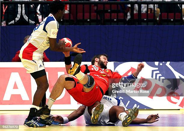 Robert Gunnarsson of Iceland falls over Luc Abalo of France during the Men's Handball European semi final match between Iceland and France at the...