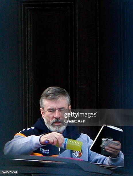 Sinn Fein President Gerry Adams prepares to enter the front gates of Hillsborough Castle in Hillsborough, Northern Ireland, on January 30, 2010. The...