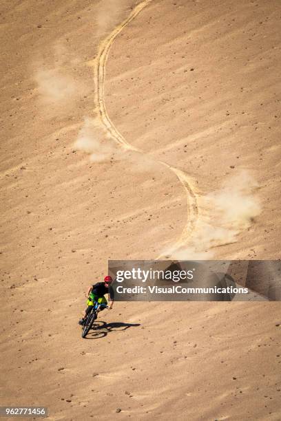 downhill mountain biker freeriding in paracas, peru. - paracas stock pictures, royalty-free photos & images