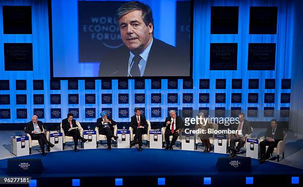 Josef Ackermann, chief executive officer of Deutsche Bank AG, on screen, participates in a panel discussion on the global economic outlook during day...