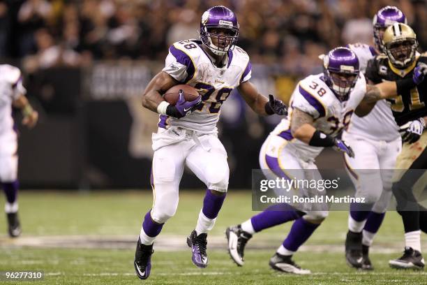 Adrian Peterson of the Minnesota Vikings runs the ball against the New Orleans Saints during the NFC Championship Game at the Louisiana Superdome on...