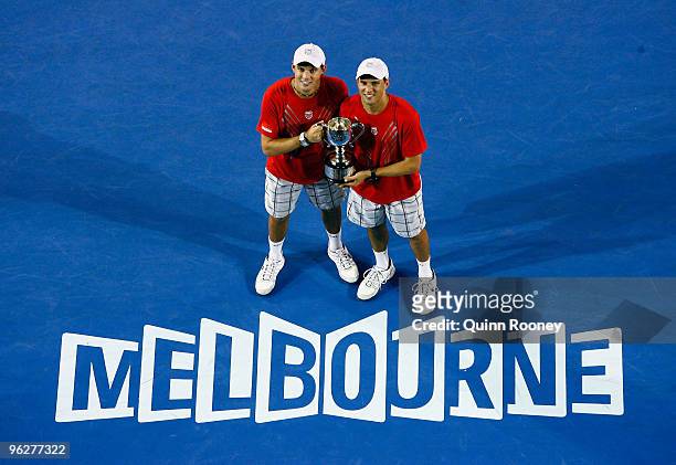 Bob Bryan and Mike Bryan of the USA kiss the championship trophy after winning their men's doubles final match against Daniel Nestor of Canada and...
