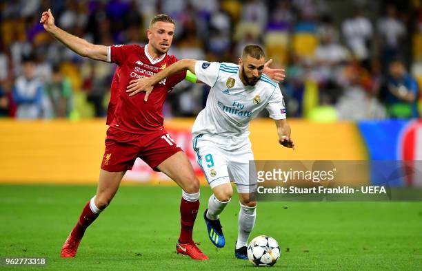 Karim Benzema of Real Madrid is challenged by Jordan Henderson of Liverpool during the UEFA Champions League Final between Real Madrid and Liverpool...