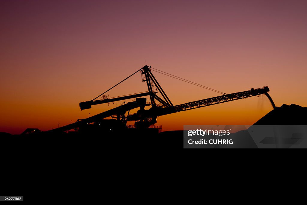 Reclaimer against the sunset on a Iron Ore Mine Site