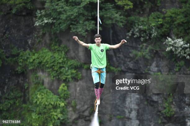 Member of slacklining musical band Houle Douse, a musical band from Marseille, France, performs on slacklines across 1,400-meter-high cliffs during...