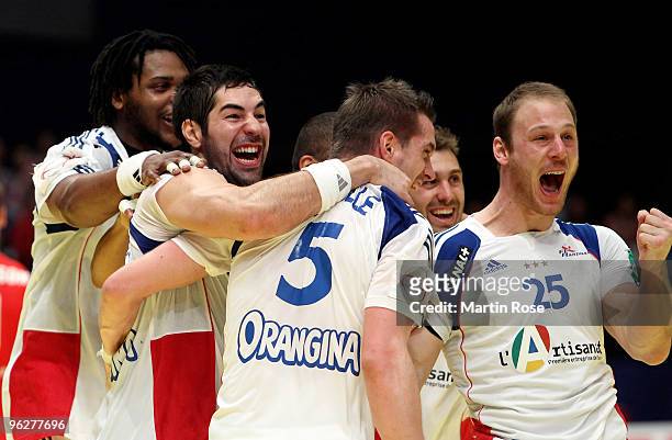 Guillaume Gille of France celebrates with team mate Nikola Karabatic and Gregoire Detrez after the Men's Handball European semi final match between...