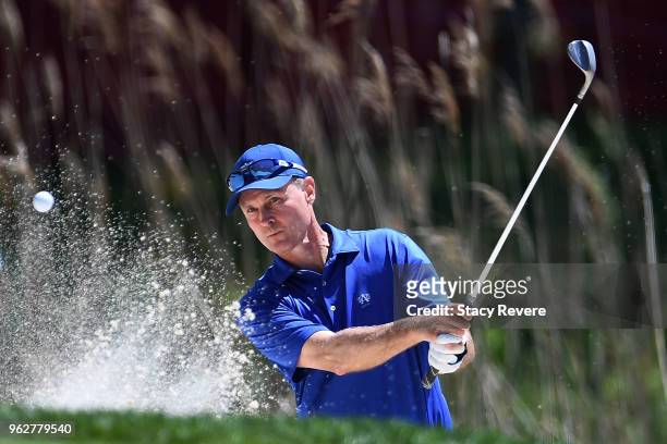 Bob Estes hits from a green side bunker on the 17th hole during the third round of the Senior PGA Championship presented by KitchenAid at the Golf...